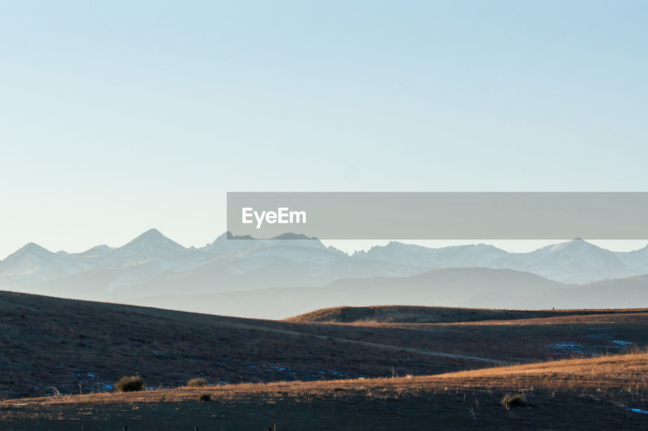 Scenic view of agricultural field against clear sky