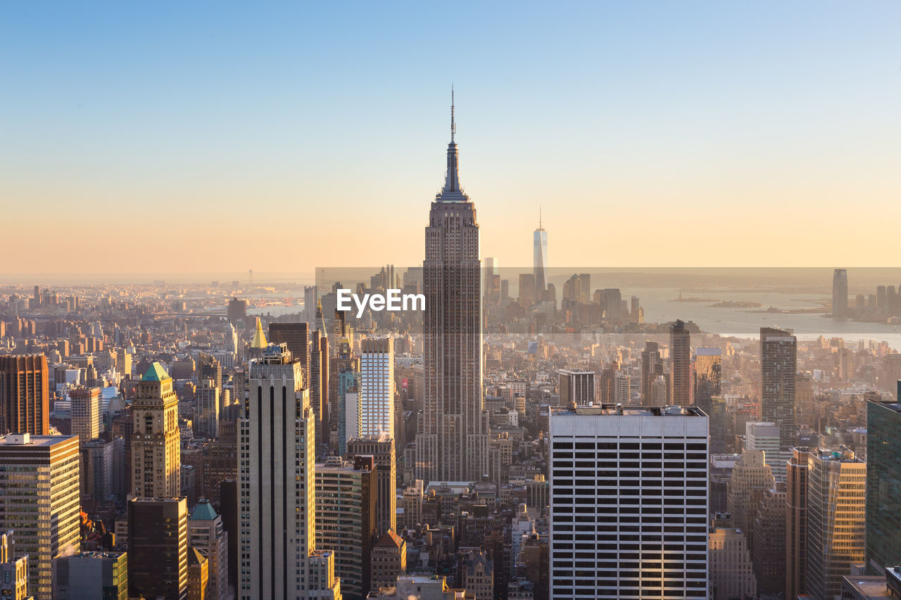 AERIAL VIEW OF BUILDINGS AGAINST SKY IN CITY