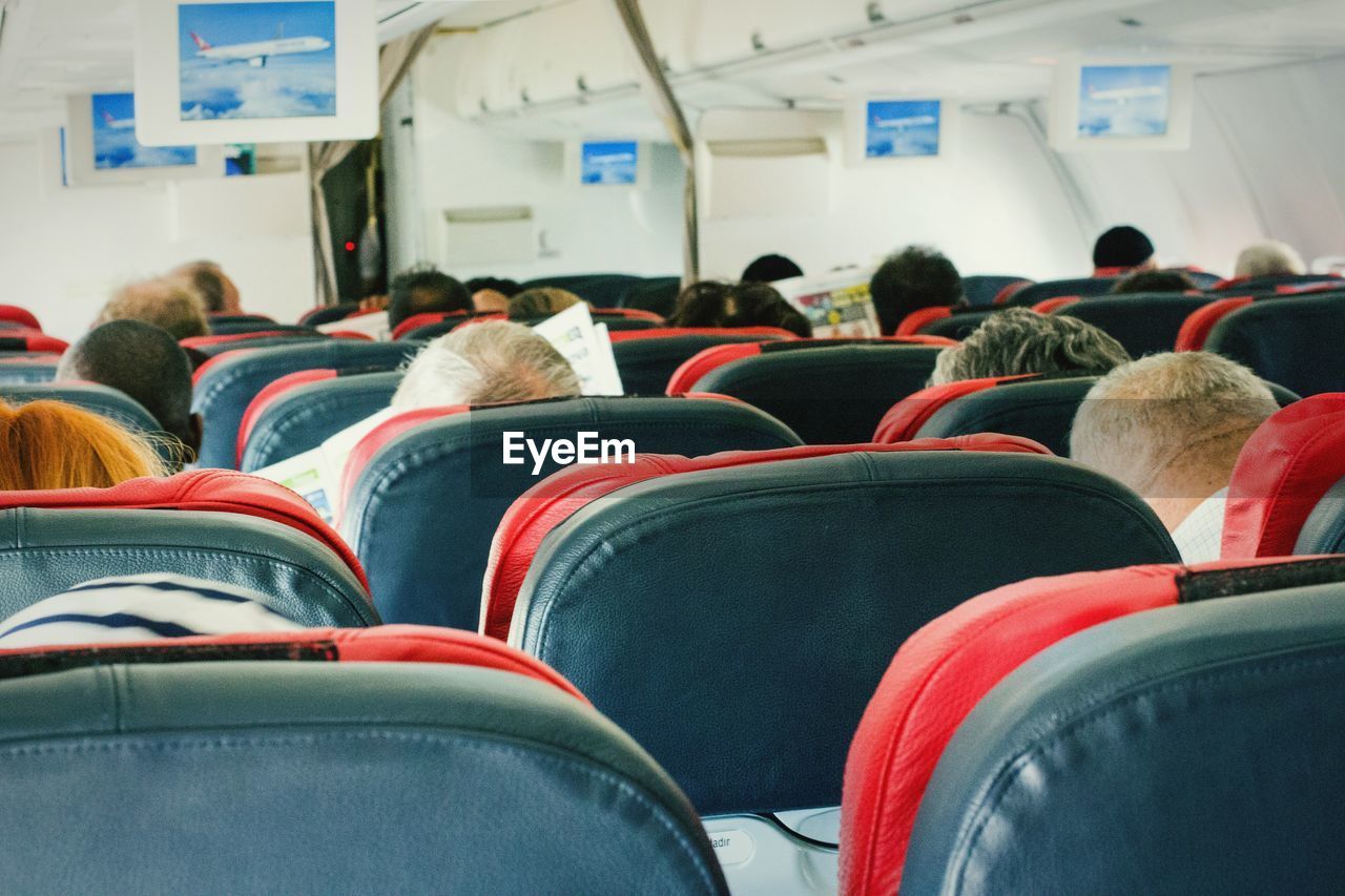 People sitting on seat in airplane