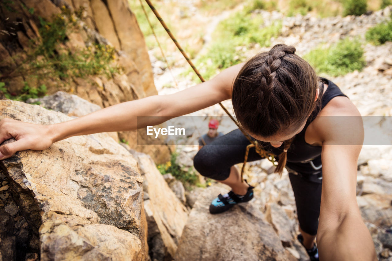 FULL LENGTH OF WOMAN WITH ROCKS