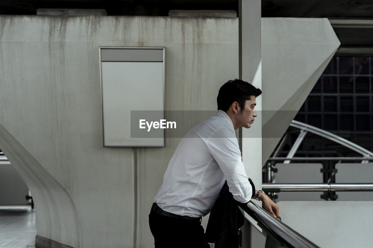 Low angle view of businessman standing in city