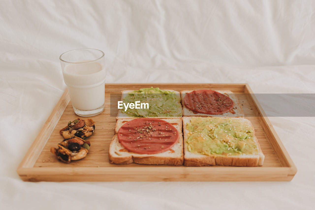 food and drink, food, indoors, breakfast, meal, healthy eating, dish, drink, freshness, no people, studio shot, cutting board, wellbeing, high angle view, refreshment, dairy, household equipment, fruit, glass, wood, produce, vegetable, still life, drinking glass