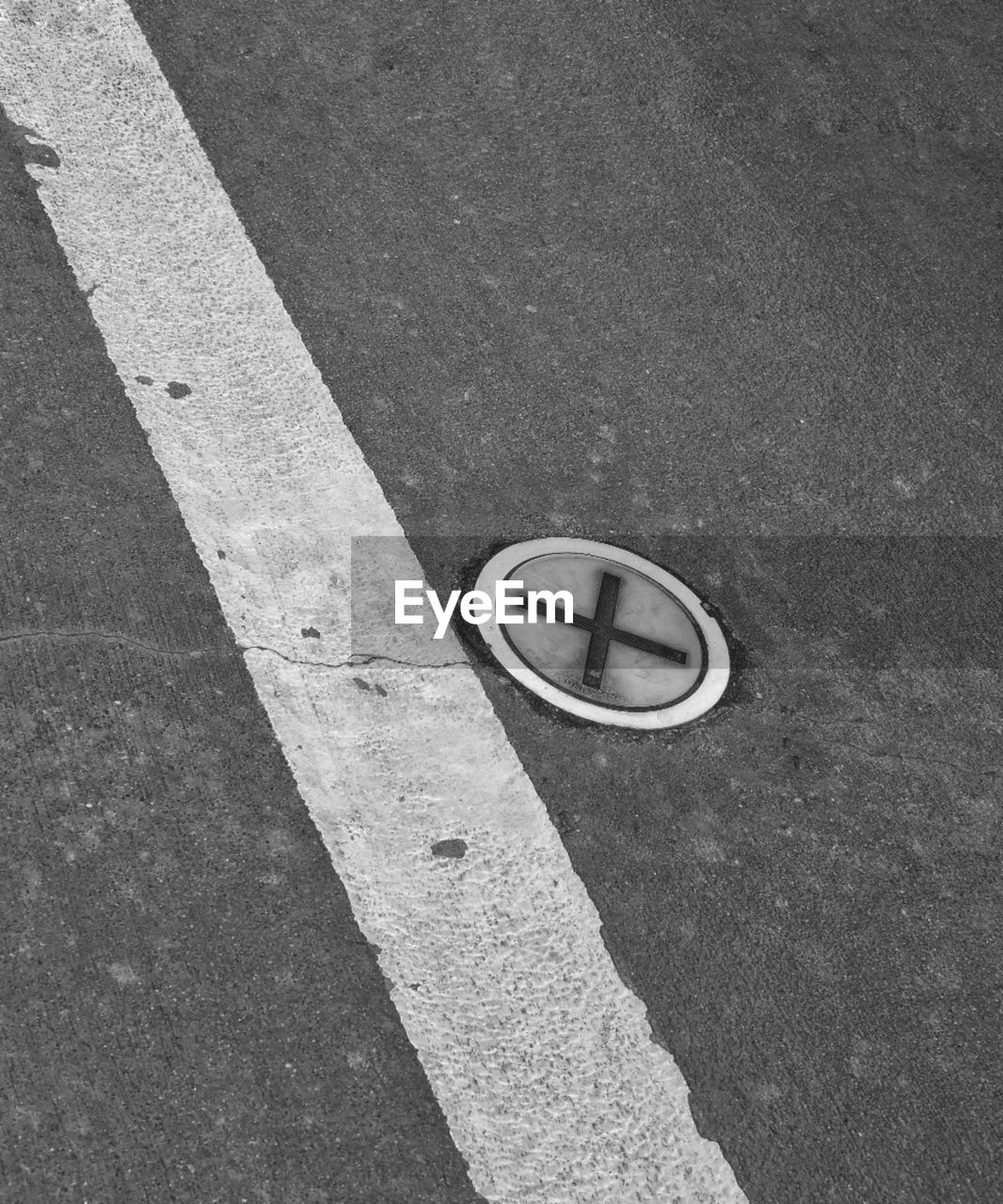white, black, road, high angle view, symbol, line, transportation, black and white, circle, asphalt, road marking, sign, street, marking, day, monochrome, city, monochrome photography, no people, road surface, shadow, outdoors, floor, number, flooring, guidance, lane, geometric shape, communication