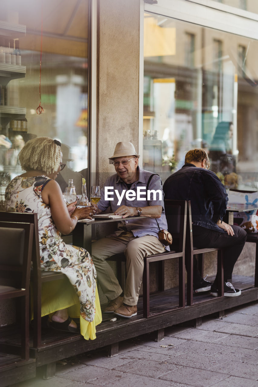 Heterosexual couple sitting in sidewalk cafe