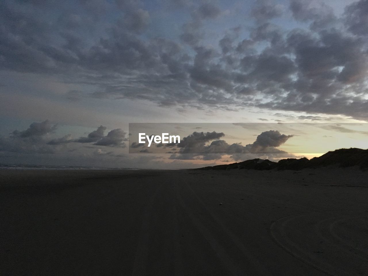 Scenic view of dramatic sky over silhouette landscape