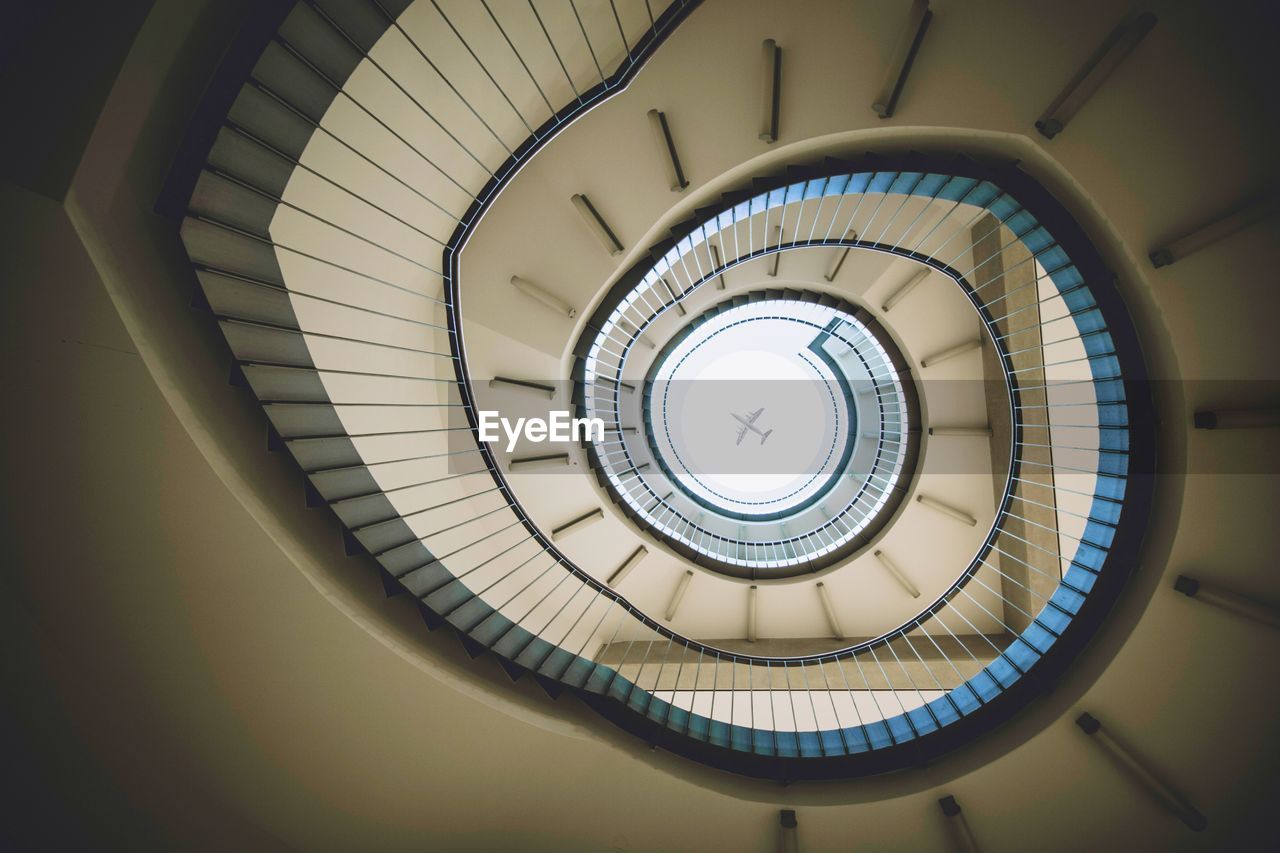 Directly below view of spiral staircase in building