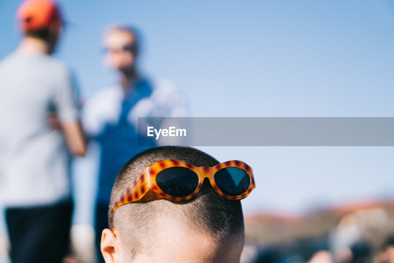 Close-up of boy wearing sunglasses on head