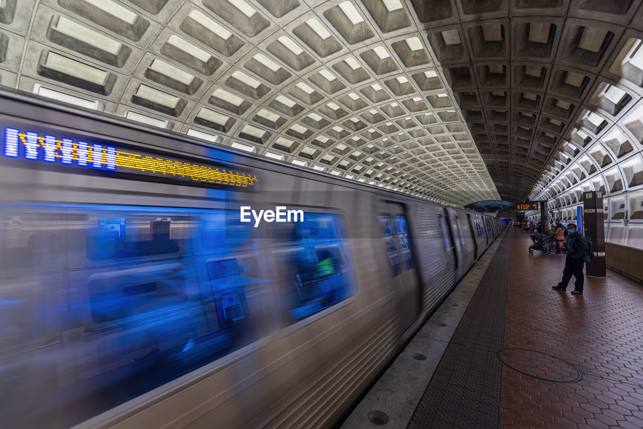 TRAIN ON RAILROAD STATION PLATFORM