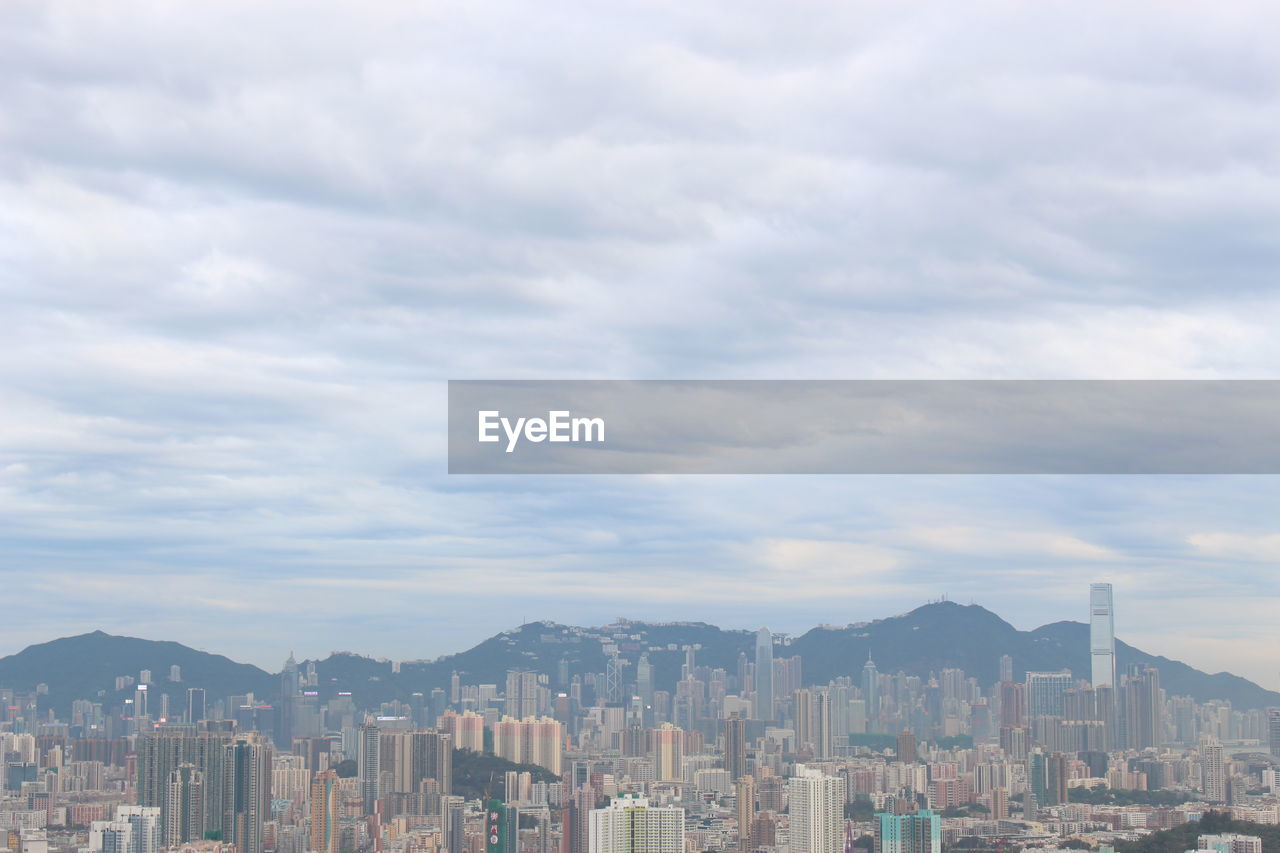 Panoramic view of buildings in city against sky