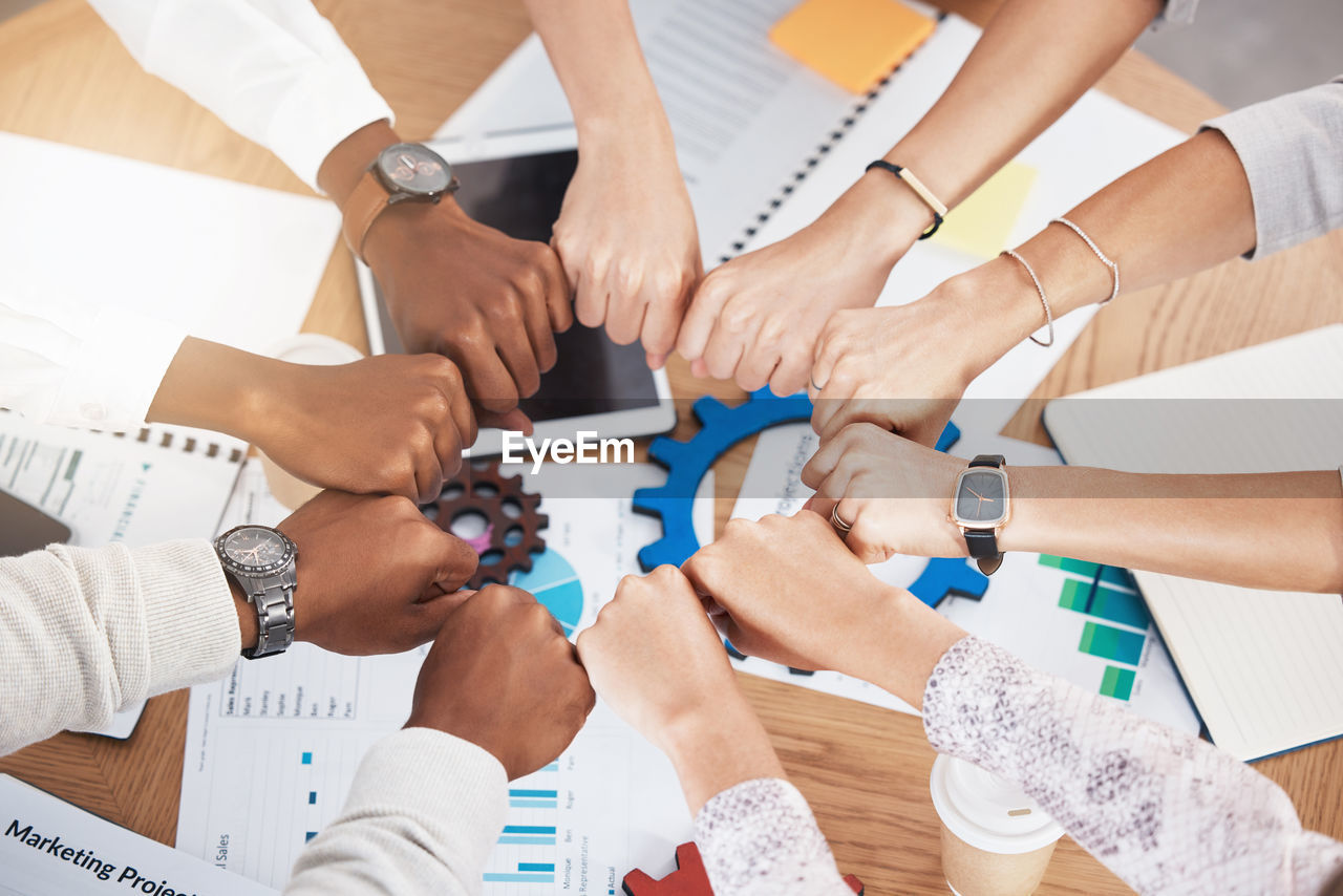 high angle view of business colleagues stacking hands