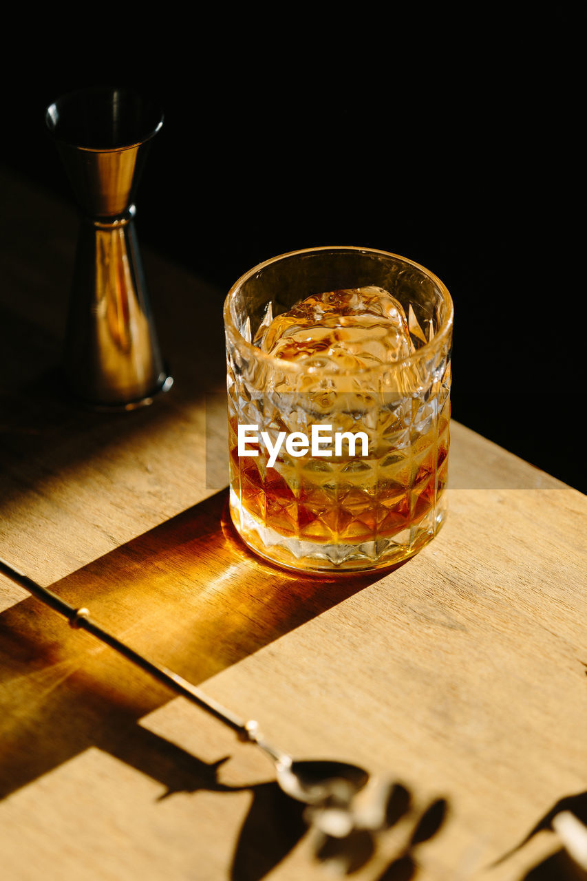 Close-up of glass with bourbon whiskey on table