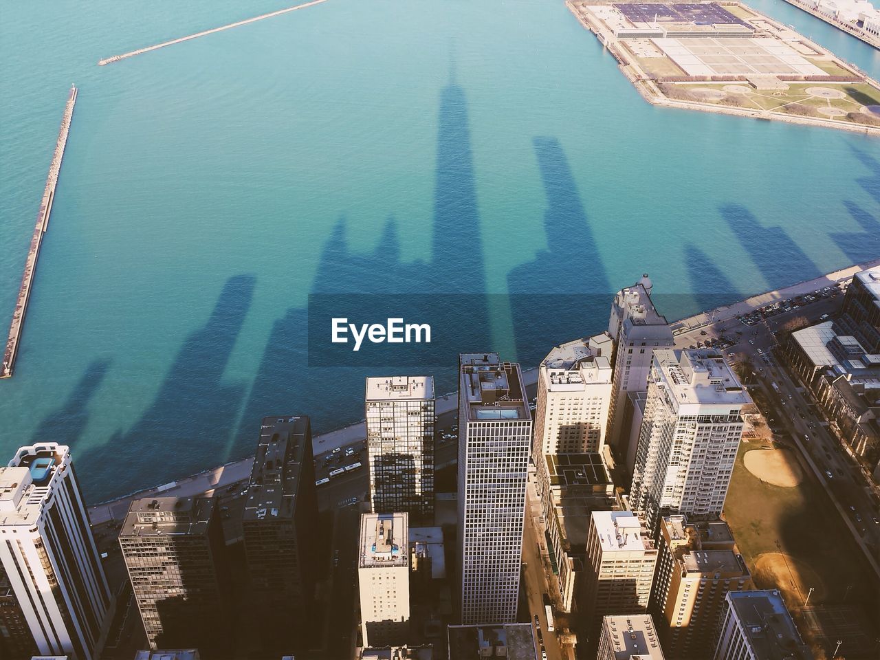 Shadow of city skyline on sea