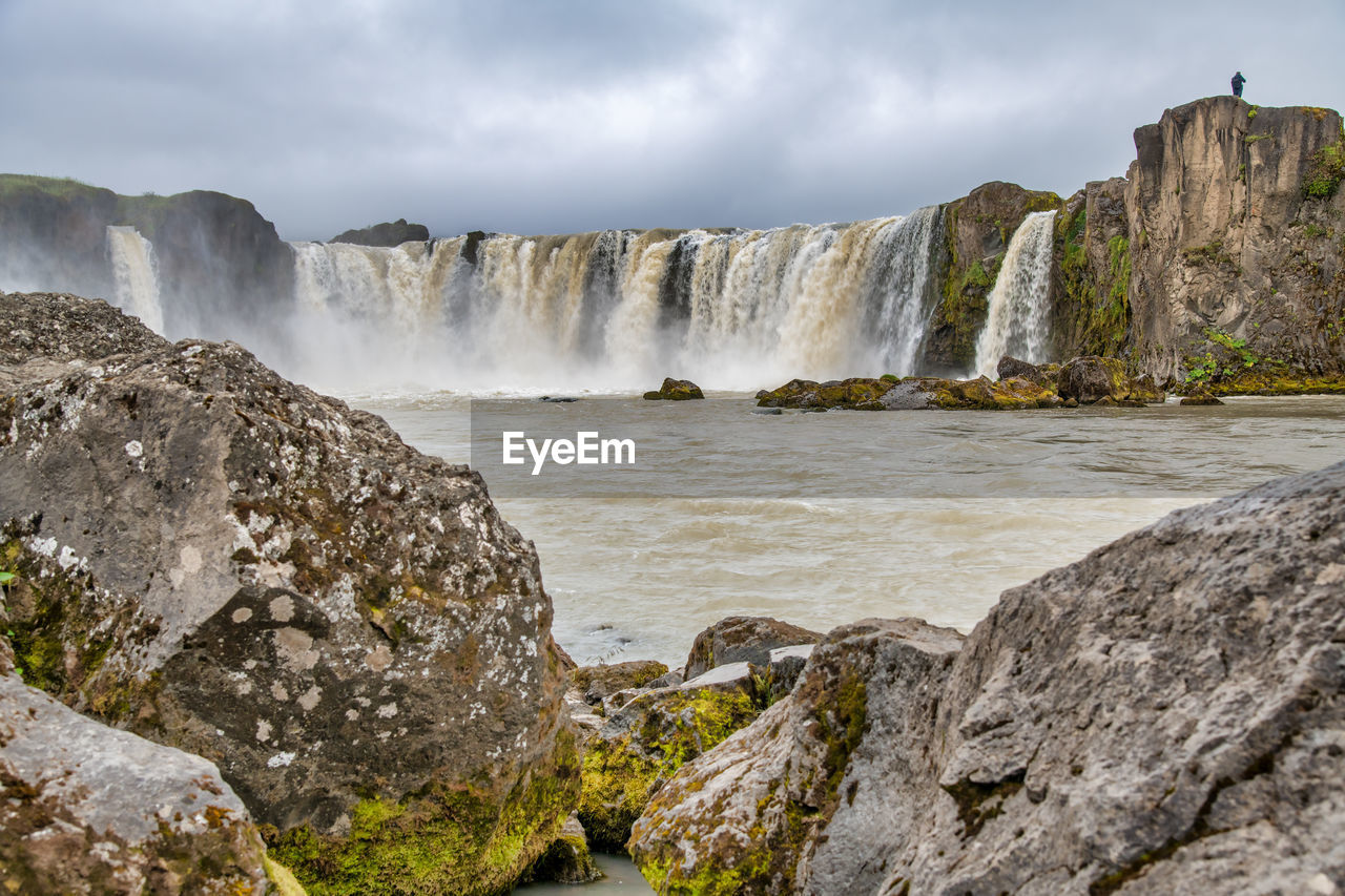 SCENIC VIEW OF WATERFALL AT COAST