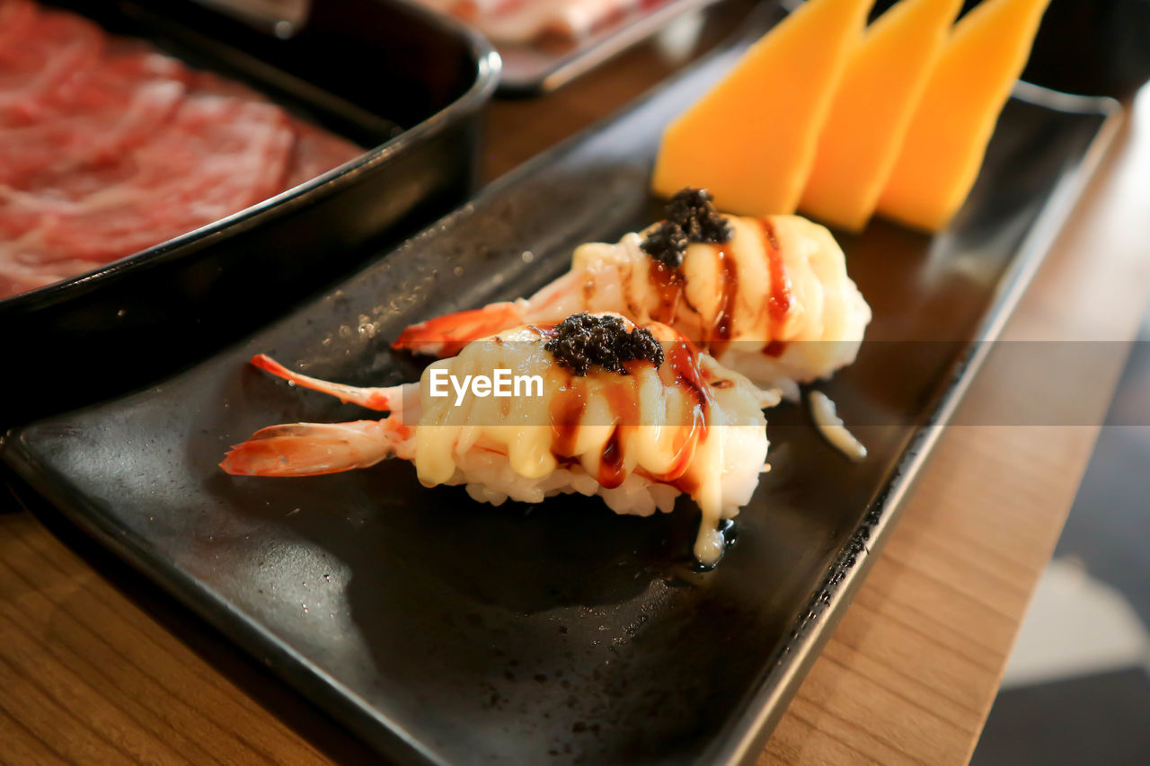 CLOSE-UP OF SUSHI SERVED IN PLATE