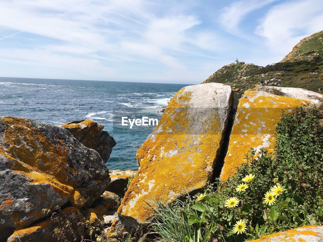 Rock formations on sea shore against sky