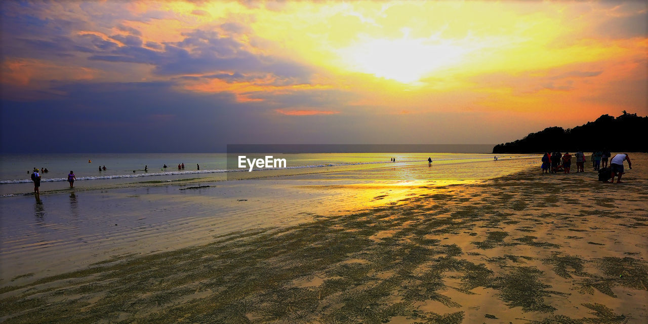 PEOPLE ON BEACH DURING SUNSET