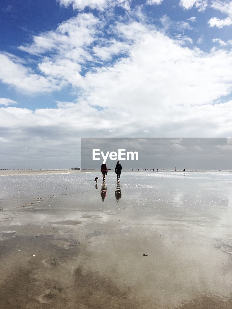 PEOPLE ENJOYING AT BEACH AGAINST SKY