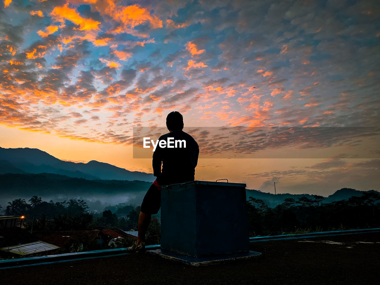 REAR VIEW OF SILHOUETTE MAN STANDING BY MOUNTAIN AGAINST SKY