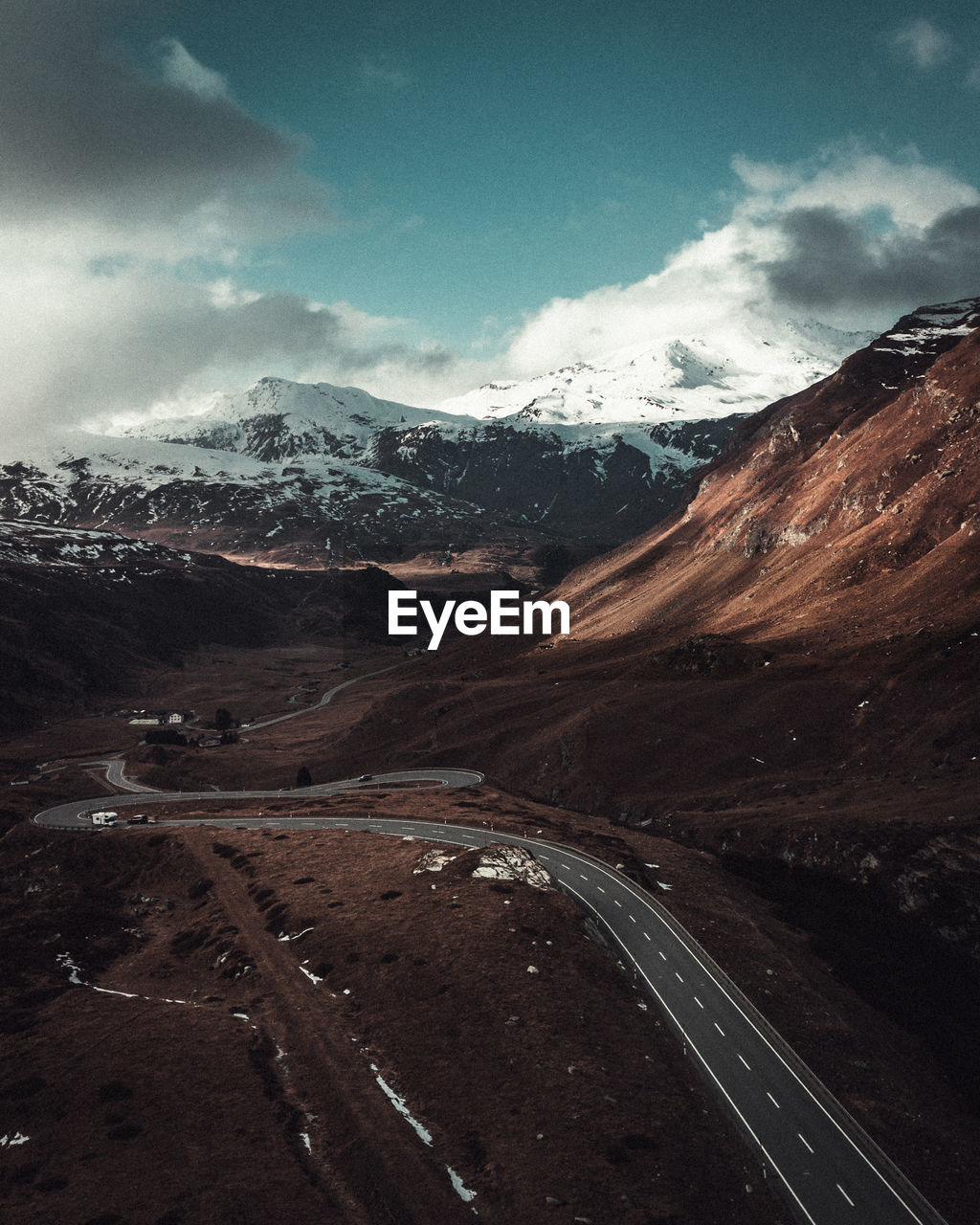 Road amidst mountains against sky