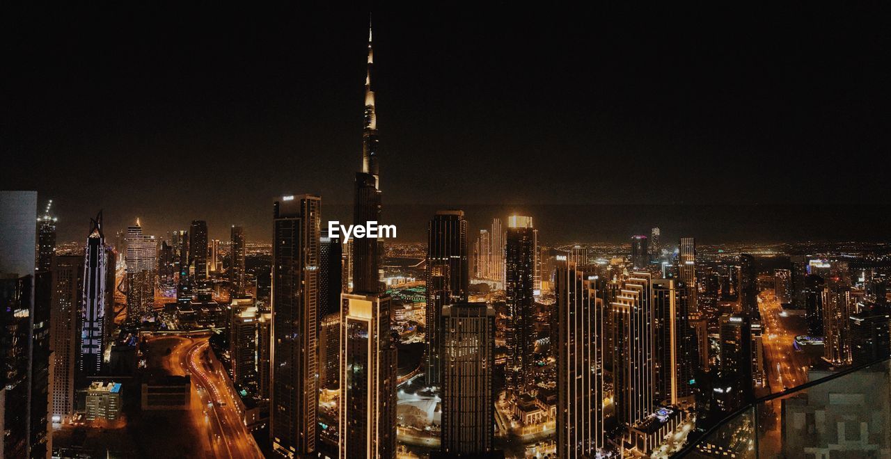 high angle view of illuminated cityscape against sky at night