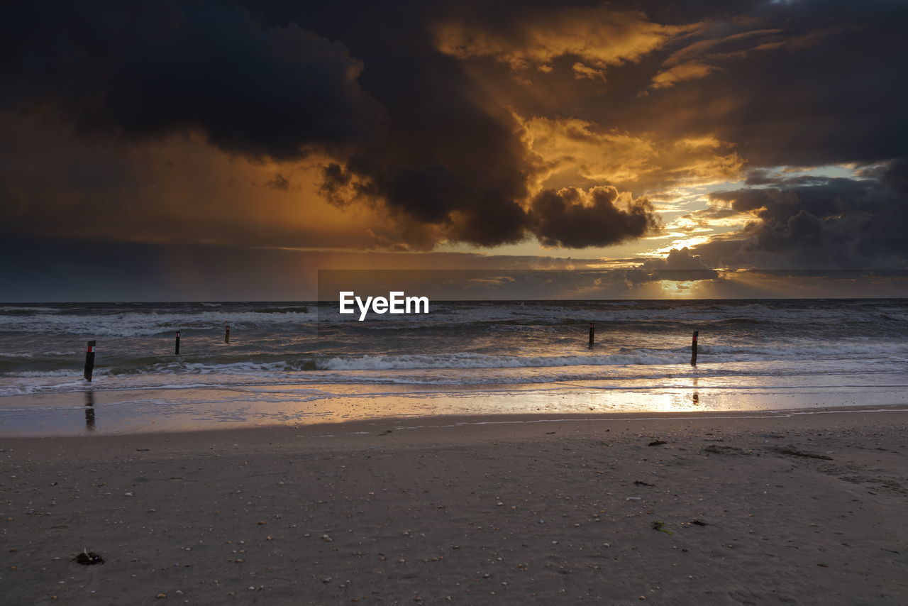 SCENIC VIEW OF BEACH DURING SUNSET