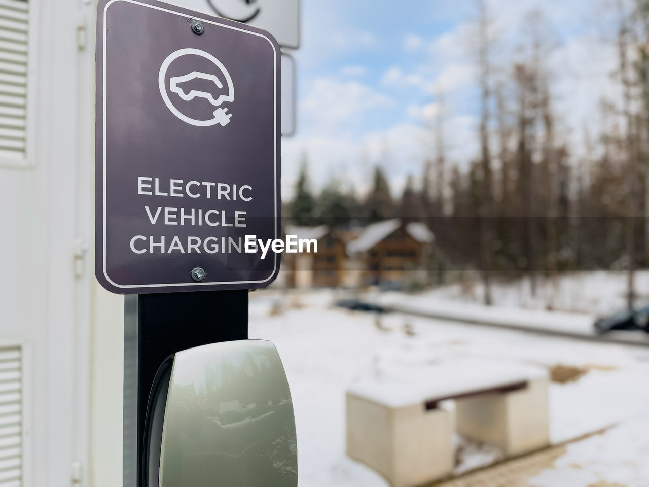 Electric vehicle charging station for powering electric cars on parking in a residential area. green