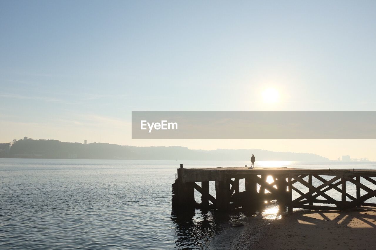 SILHOUETTE PIER OVER SEA AGAINST SKY