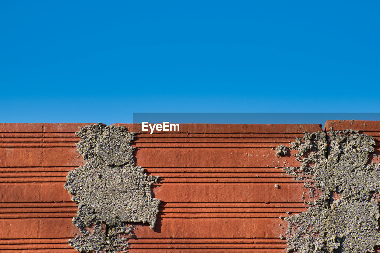 Low angle view of old building against blue sky