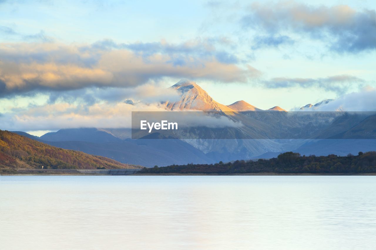 Scenic view of lake and mountains against sky