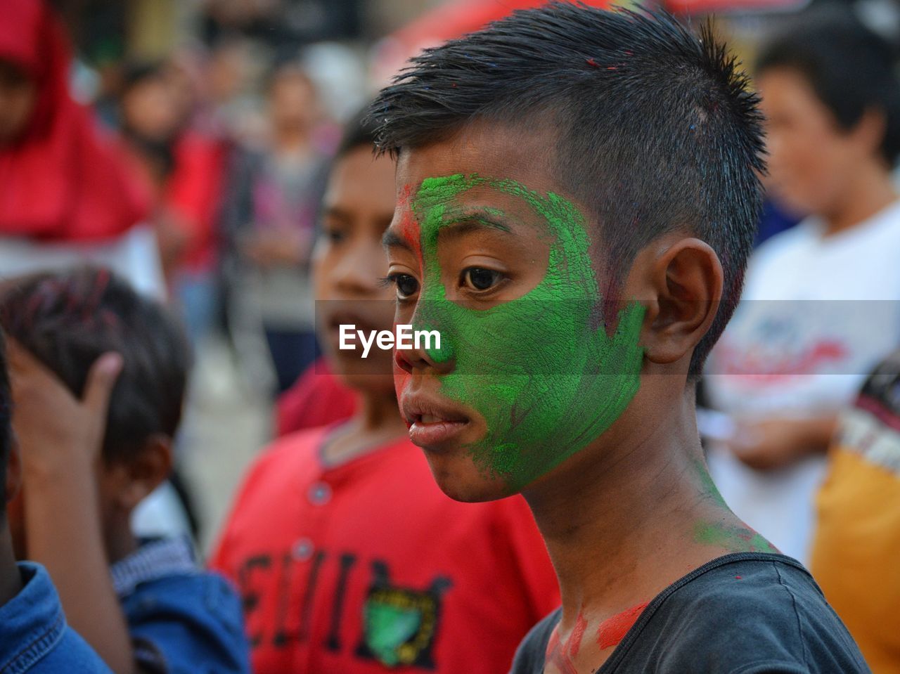 Close-up of boy with green face paint during celebration