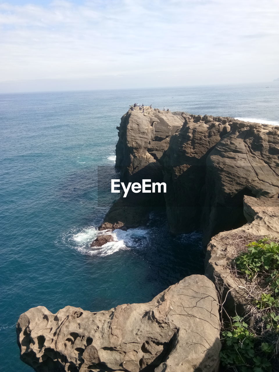 Scenic view of rock formation by sea against sky