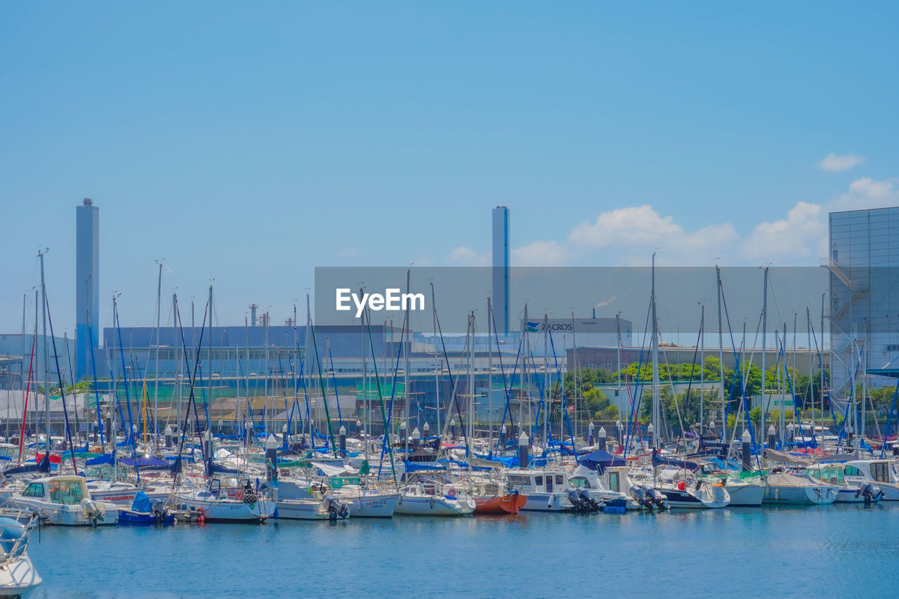 boats in harbor against clear sky