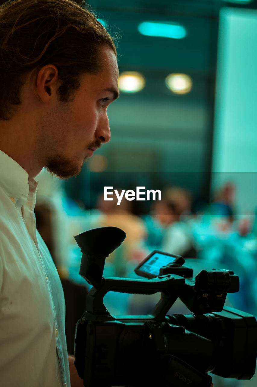 Side view of young filmmaker