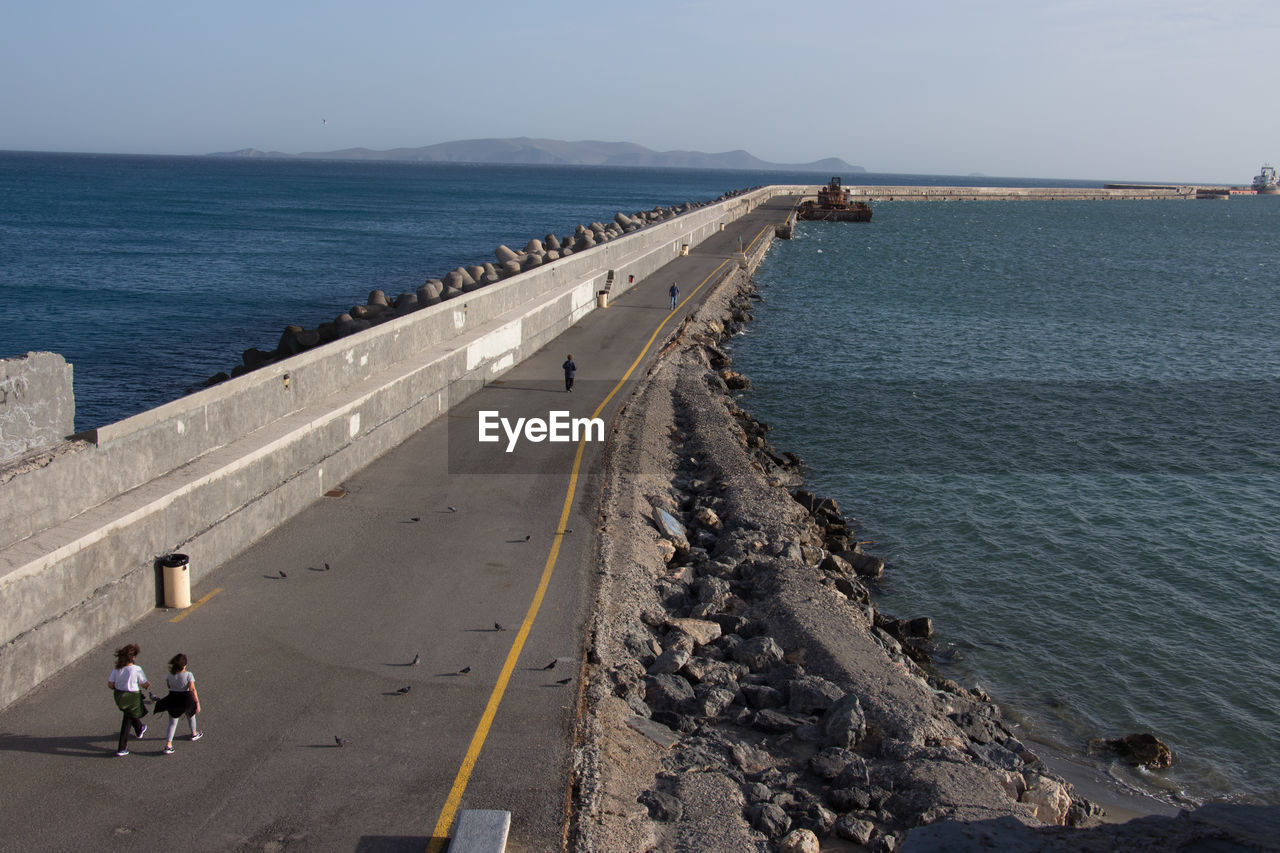 High angle view of women by sea on road