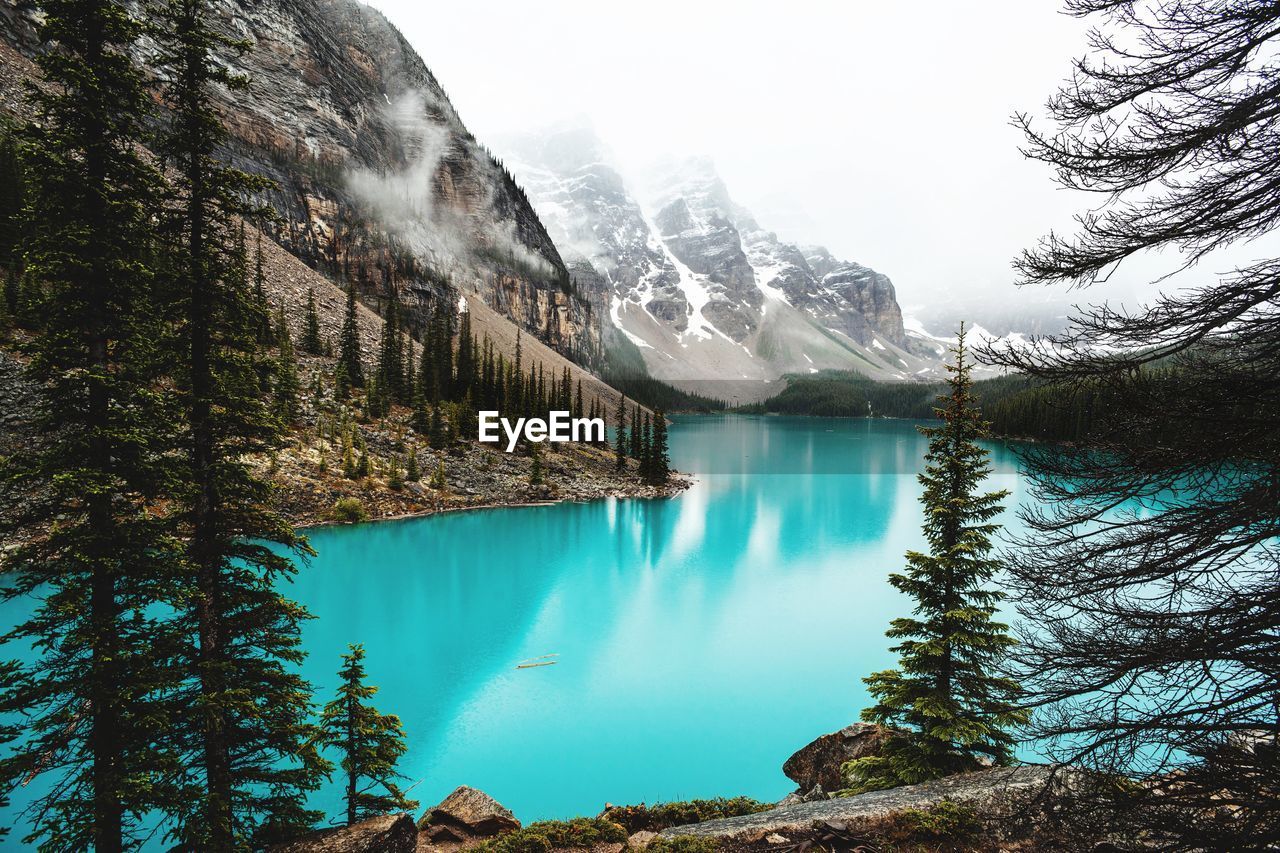 Scenic view of lake and mountains against sky