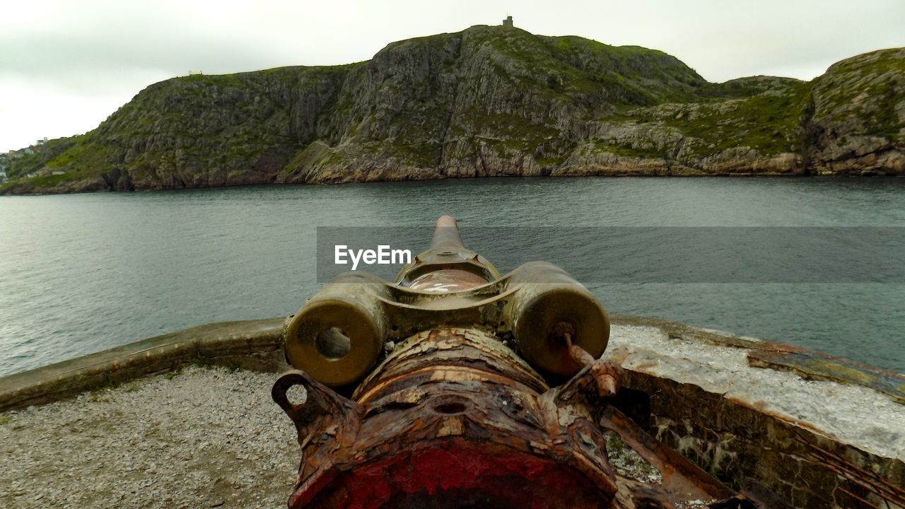 Cannon against sea and mountains