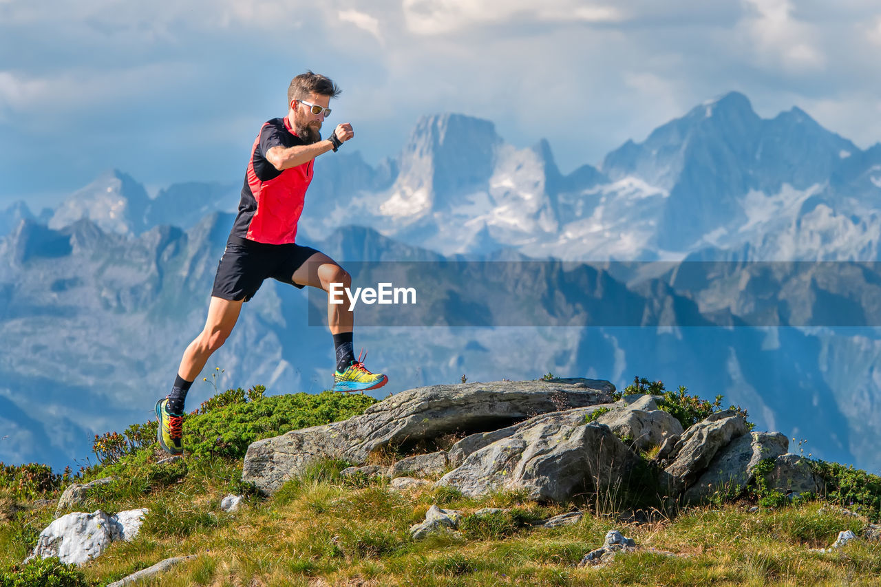 A skyrunner athlete man trains in the high mountains.