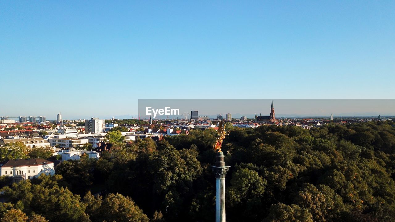 architecture, sky, horizon, built structure, city, building exterior, skyline, clear sky, nature, plant, hill, tree, cityscape, building, no people, landmark, copy space, blue, tower, day, outdoors, travel destinations, urban area, sunny, aerial photography, high angle view, landscape, travel, dusk, sunlight, residential district, tourism, sea, environment