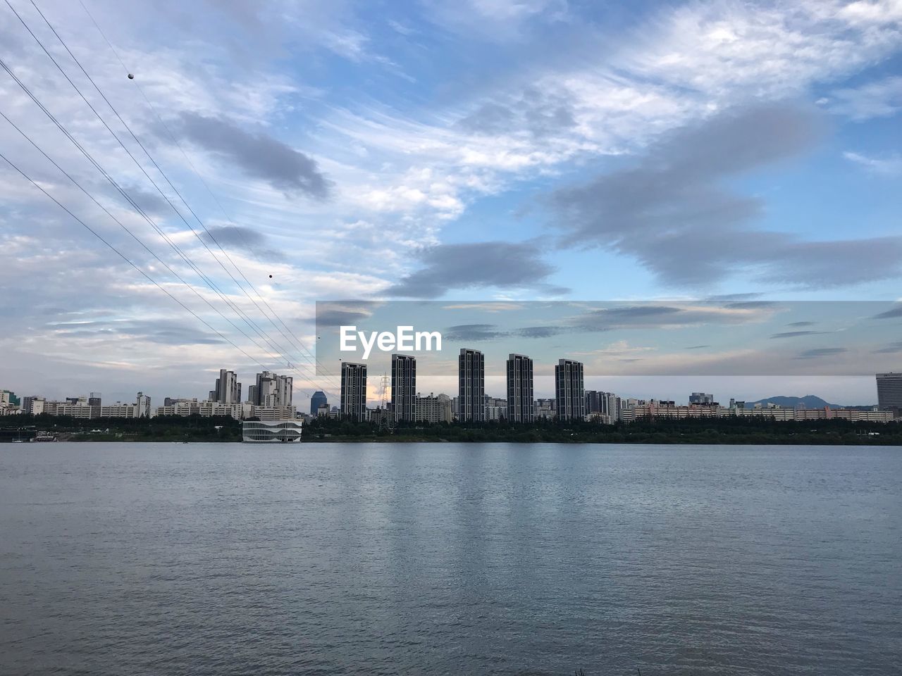 SEA AND BUILDINGS AGAINST SKY