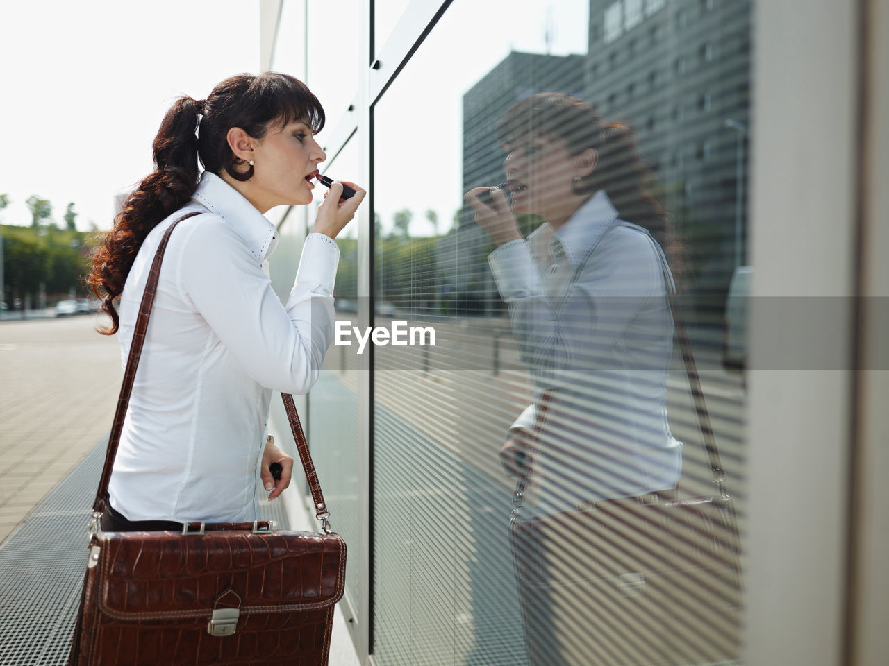 SIDE VIEW OF WOMAN STANDING BY WINDOW