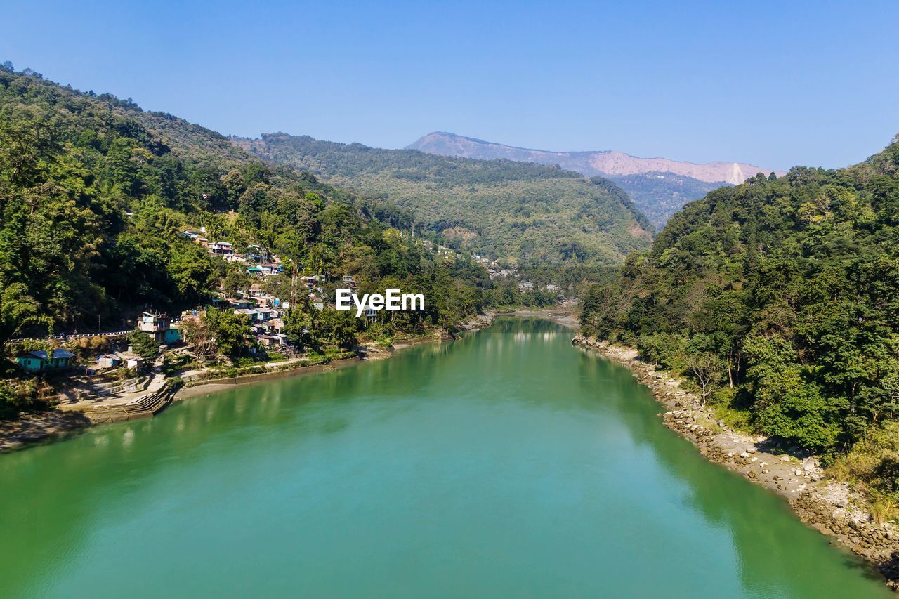 High angle view of river amidst trees against clear sky