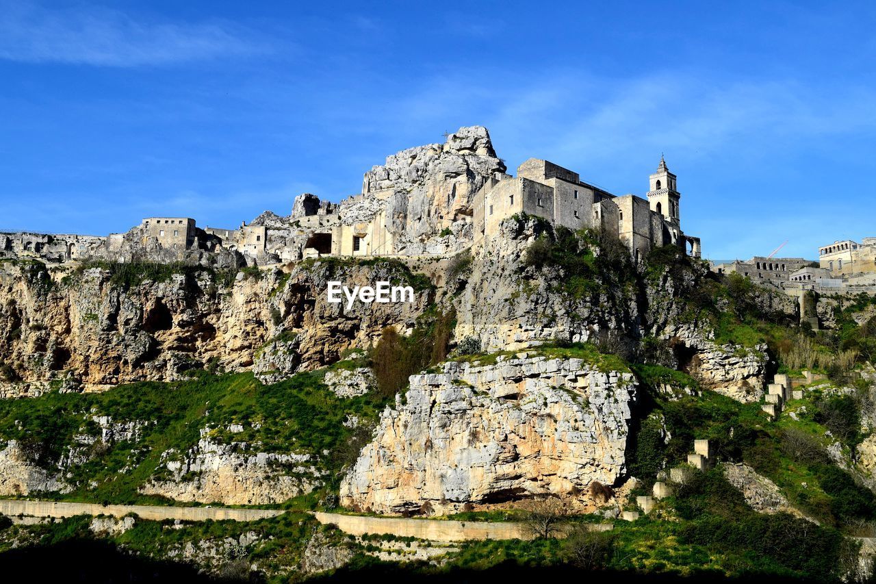 Low angle view of rock formation against sky