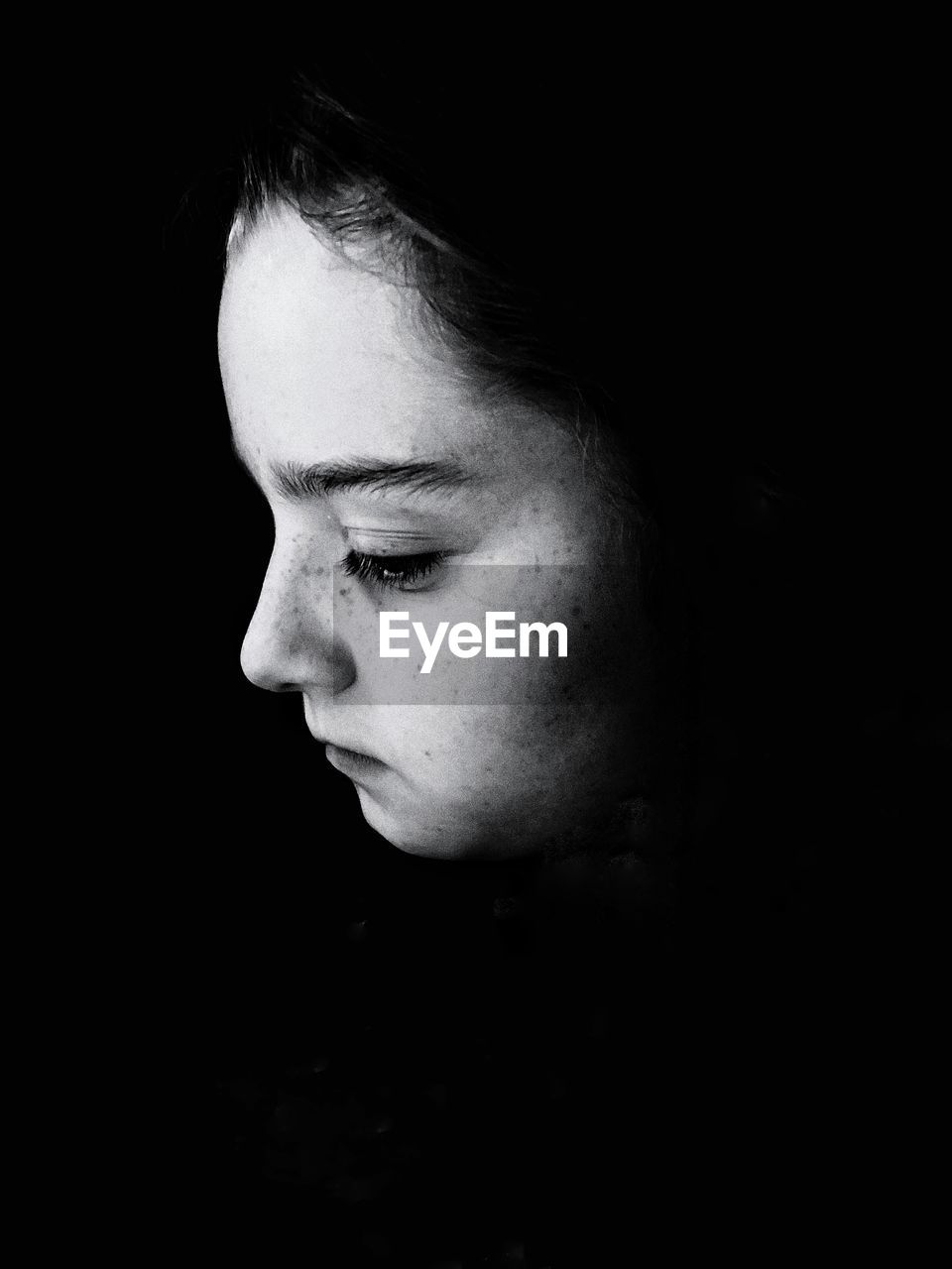 Close-up of thoughtful girl in darkroom