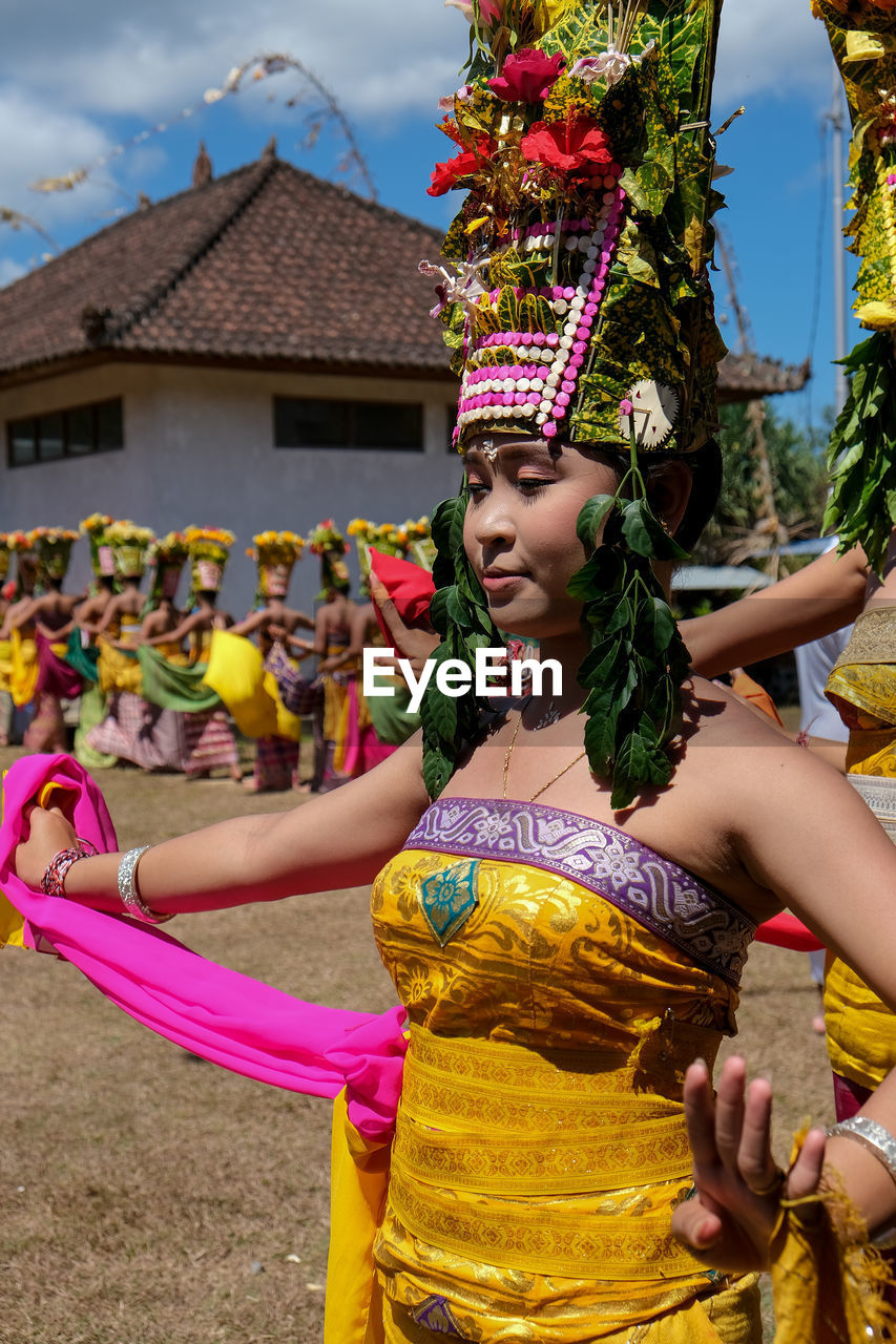 FULL LENGTH OF WOMAN HOLDING TRADITIONAL CLOTHING