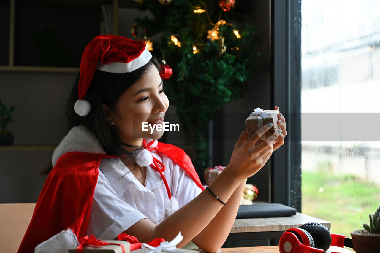 side view of young woman using phone