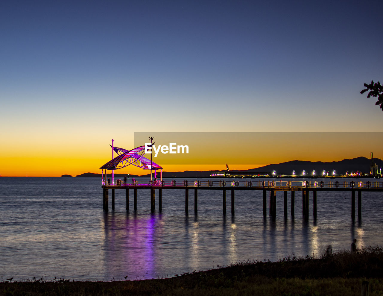 PIER OVER SEA AGAINST SKY DURING SUNSET