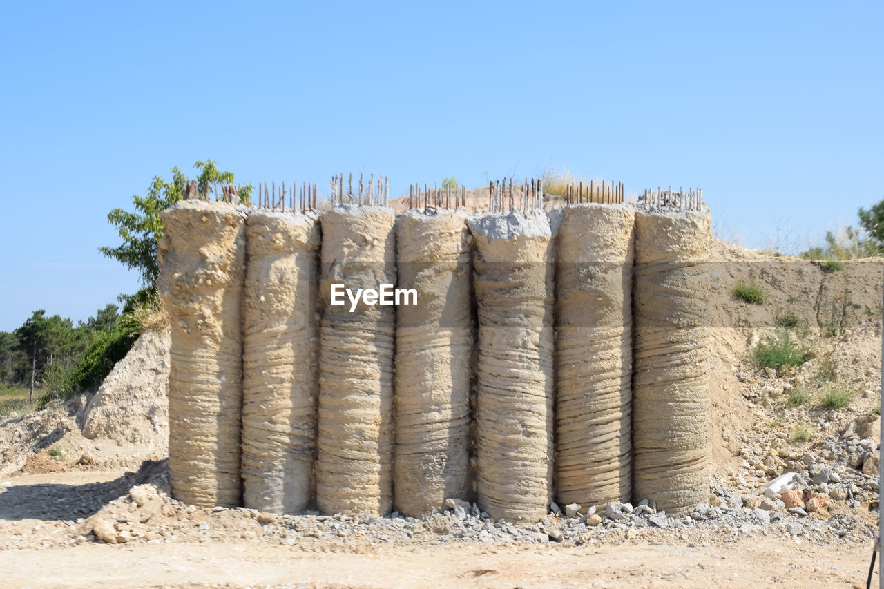 THATCHED ROOF AGAINST CLEAR SKY ON FIELD