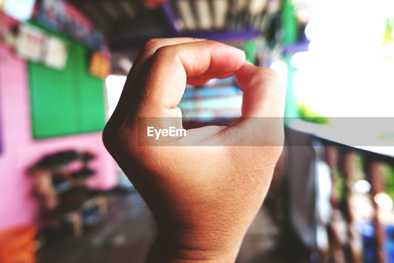 Cropped hand of person gesturing in balcony