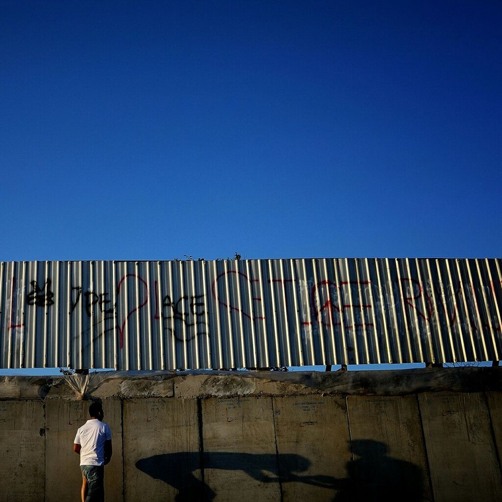 Man doing sexual harassment to woman against wall