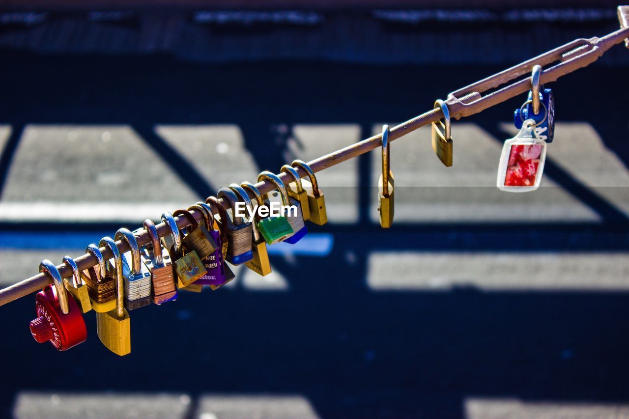 High angle view of padlocks on railing